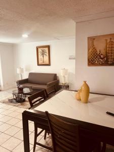 a living room with a couch and a table at Private comfortable luxury property in Orlando