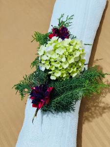 a bouquet of flowers on a white towel at Hillside cottage Nuwara Eliya in Nuwara Eliya