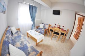 a living room with a bed and a dining room at Green View Apartments in Limenas