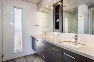 a bathroom with a sink and a mirror at Bayside Bliss in Dunsborough +26 photos