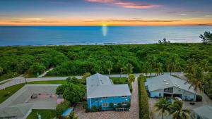 an aerial view of a house and the ocean at No-Stairs Beach Getaway - Ground Floor Pet-Friendly 2BR in Fort Pierce