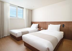 Postel nebo postele na pokoji v ubytování Hanwha Resort Gyeongju