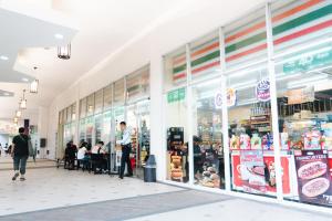 a store front of a grocery store with people walking in front at Cubao Manhattan Heights Residential Condo TA4N - Low Floor Studio with Pool & Balcony, 5 Mins Walk to Gateway Mall & Araneta Coliseum LRT MRT Cubao Quezon City - Staycations by SMS in Manila +19 photos