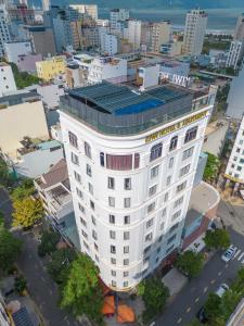 an overhead view of a white building in a city at Kiwi Beachside Hotel & Cafe Da Nang in Danang