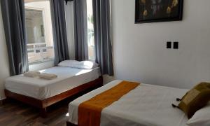 Postel nebo postele na pokoji v ubytování Villas Carlota Cancún