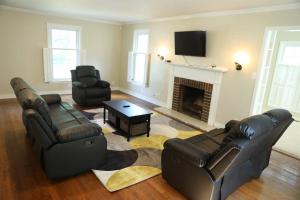 a living room with two couches and a fireplace at Destination Station in West Lafayette