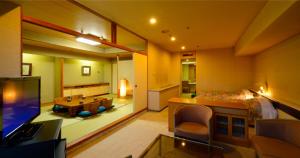 a large room with a bed and a living room at La Raku Resort Hotel Green Green in Sendai +8 photos