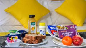 a table with a plate of breakfast food and bread at Paruna Motel in Swan Hill +4 photos