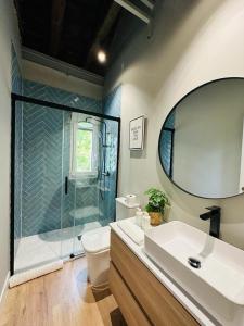 a bathroom with a shower and a toilet and a sink at La Casita de Lauri in Escorial +35 photos
