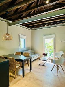 a living room with a table and a couch at La Casita de Lauri in Escorial