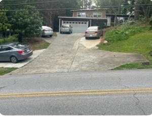 two cars parked in a driveway with a garage at Embry Hills in Habersham