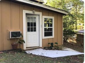a small house with a white door and a window at Embry Hills in Habersham