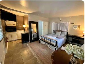 a bedroom with a bed with a desk and a kitchen at Embry Hills in Habersham