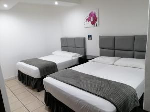 Postel nebo postele na pokoji v ubytování Apart Hotel Express