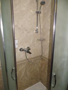 a shower with a hose in a bathroom at 100 metriv vid vytyagu in Bukovel +22 photos