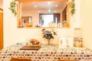 a table with a table cloth on it with a mirror at 楽Home in Otaru
