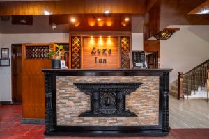 a fireplace in the middle of a lobby at The Luxe Inn Boutique Hotel in Kathmandu