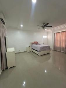 Un dormitorio con una cama y un ventilador de techo. en Tranquil Haven Villa, en Kumasi