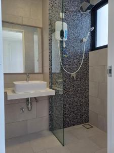 a bathroom with a sink and a shower at The Shore Cozy Suite in CBD in Kota Kinabalu