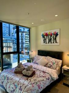 a bedroom with a bed with towels on it at Apartment 405 8 Daly St South Yarra 3141 LUCIA in Melbourne