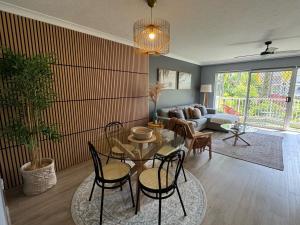 a living room with a table and chairs and a couch at Mari Court Resort in Gold Coast