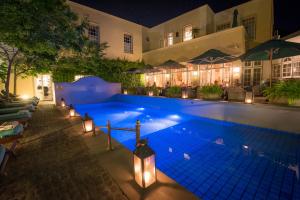 a swimming pool at night with lights at Hout Bay Manor in Hout Bay