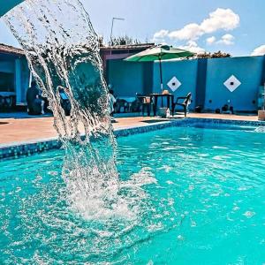 a fountain in the water in a swimming pool at Praia das Dunas SE in Estância