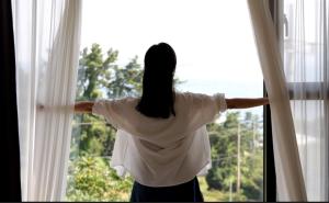 a woman is looking out of a window at beotkkotgil jinaseo in Namhae +73 photos