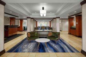 a lobby with chairs and a table on a rug at Fairfield Inn & Suites Bedford in Bedford