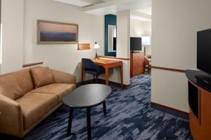 a living room with a couch and a table at Fairfield Inn & Suites Bedford in Bedford