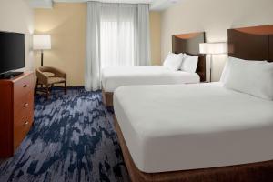 a hotel room with two beds and a flat screen tv at Fairfield Inn & Suites Bedford in Bedford +15 photos
