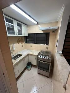 a small kitchen with a stove and a sink at Casa Vl Mariana-Próx SP Expo-com garagem in Sao Paulo