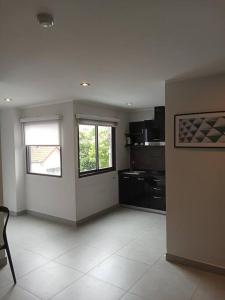 a large kitchen with two windows in a room at Large Corner Apartment 1BR - NV-207 in Ban Klang