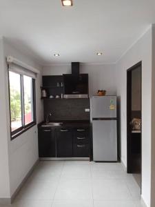 a kitchen with a refrigerator and a sink at Large Corner Apartment 1BR - NV-207 in Ban Klang +4 photos