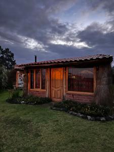 a small house with a window on the side of it at Wasi Andina Lodge in Latacunga