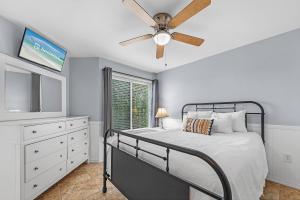 a bedroom with a bed and a ceiling fan at Plantation West Condos in Gulf Highlands