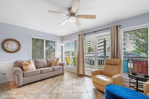 a living room with a couch and a ceiling fan at Plantation West Condos in Gulf Highlands