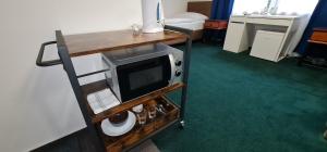 a room with a microwave on a table with a bed at Apartmány Orlová in Orlová