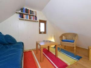 a room with a couch and a table and a chair at Holiday home Keim Comfortable Vacation Home in Negenborn +7 photos