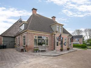 a brick house with a bench in front of it at Guesthouse Friesland Ternaard near Heritage in Ternaard