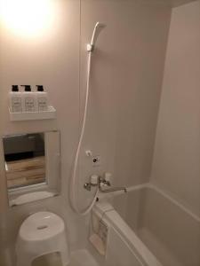 a white bathroom with a toilet and a bath tub at SapporoCity Ark Coat 203 in Minami-jūichijō +36 photos