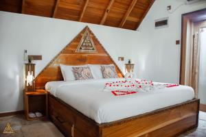a bedroom with a large bed with a triangular headboard at The Triangle Tangalle in Tangalle