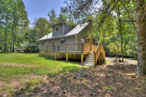 a house with a deck and stairs in a yard at Aska River House - Riverside relaxation and all the comforts of home in Blue Ridge