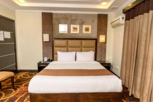 Postel nebo postele na pokoji v ubytování Hotel One Abbottabad