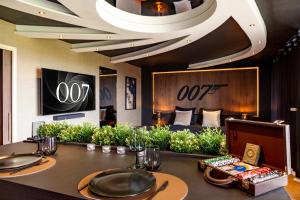 a luxury hotel room with a table and a couch at Escapade 007 Refuge d Agent in Blois