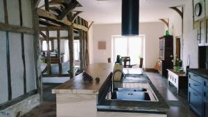a kitchen with a sink and a counter top at La Coquille in Pouillon