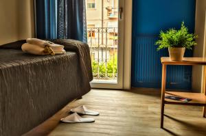 a bedroom with a bed and a window and shoes at Hotel La Terrazza in Vicenza