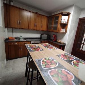 a kitchen with a table with plates of food on it at H & L Fogar do Camiño in Padrón +3 photos