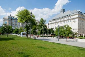 a park in a city with buildings and grass at Gloria Apartment in Budapest