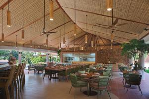 a dining room with tables and chairs and ceiling at The Westin Desaru Coast Resort in Desaru